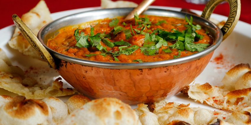 Indian curry with flatbread served at Kalpataru Restaurant, one of the top restaurants in Siliguri.
