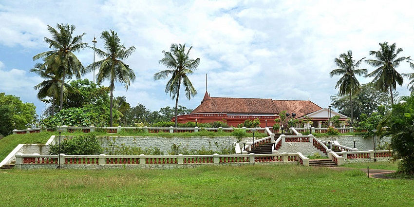 Heritage red brick landmark inside Kanakakunnu Palace, among historic parks in Kerala.
