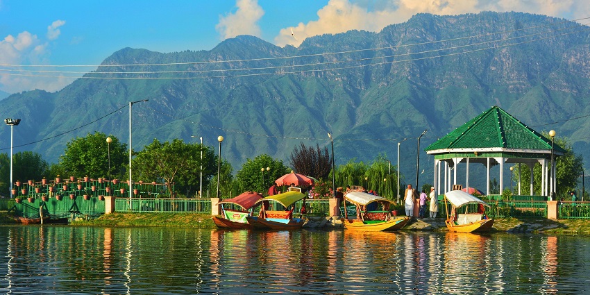 Scenic view of Kangra in Himachal Pradesh, showing hills and valleys under a clear sky.
