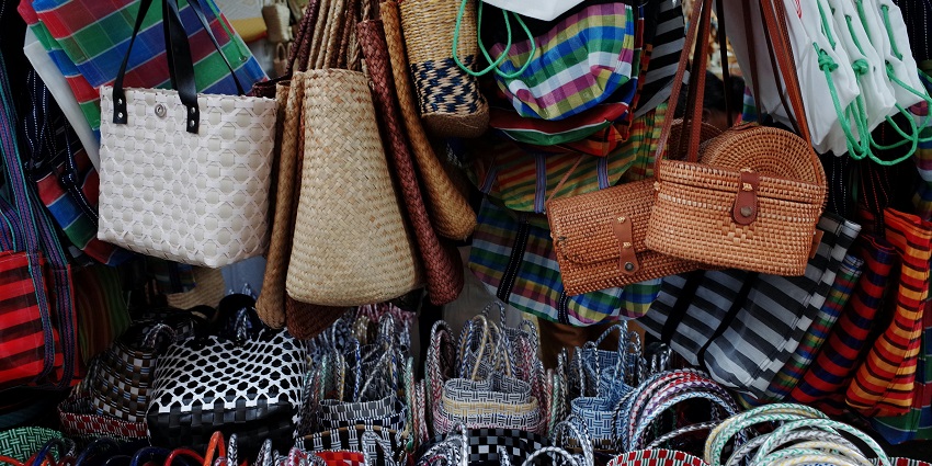 Close-up of handwoven bags are displayed at Kasaragod Coir Centres, one of the best places for shopping in Kerala.
