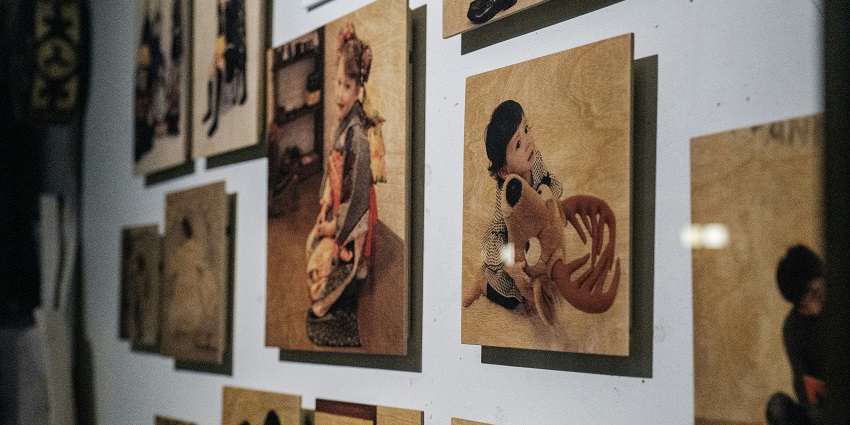 Close-up view of paintings displayed on the wall at a museum art gallery in Kerala.