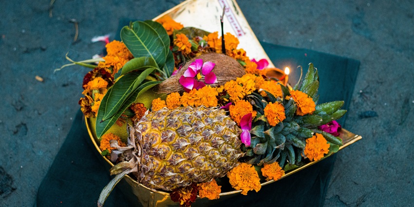 A thali filled with fruits and flowers is prepared as offerings to the Sun God during Chhath Puja rituals.