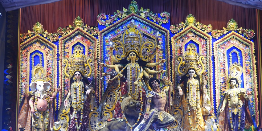 An intricately decorated Durga Puja pandal featuring the idols of Goddess Durga.
