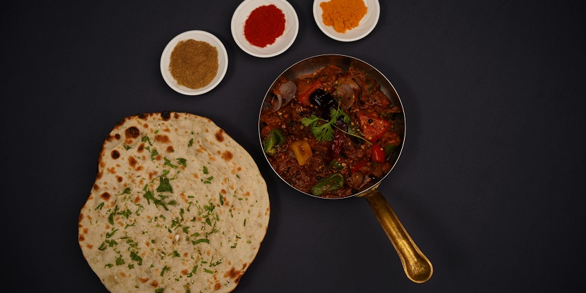 Indian curry served with laccha paratha at Kunjini Restaurant.