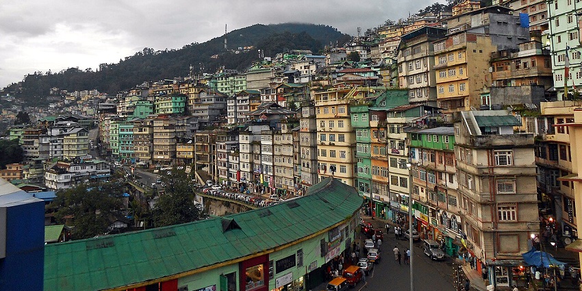 Colourful buildings on a hillside in Gangtok, showcasing vibrant shopping in Sikkim’s urban landscape.