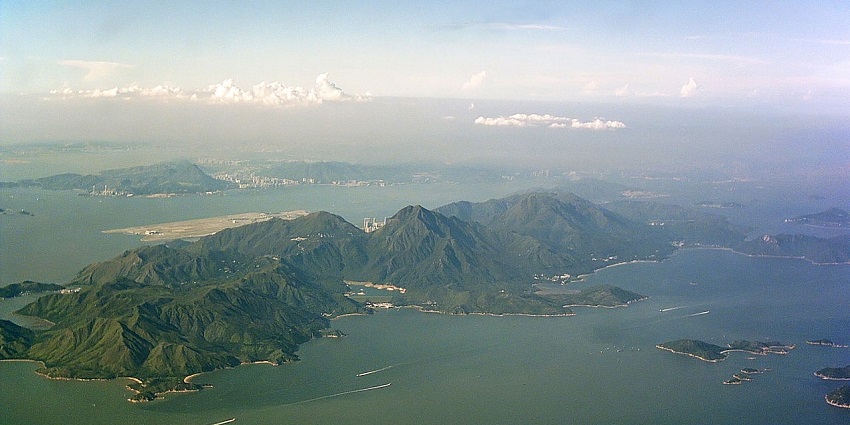 Aerial view of Lantau Island with green cliffs and vast waters in islands in Hong Kong.