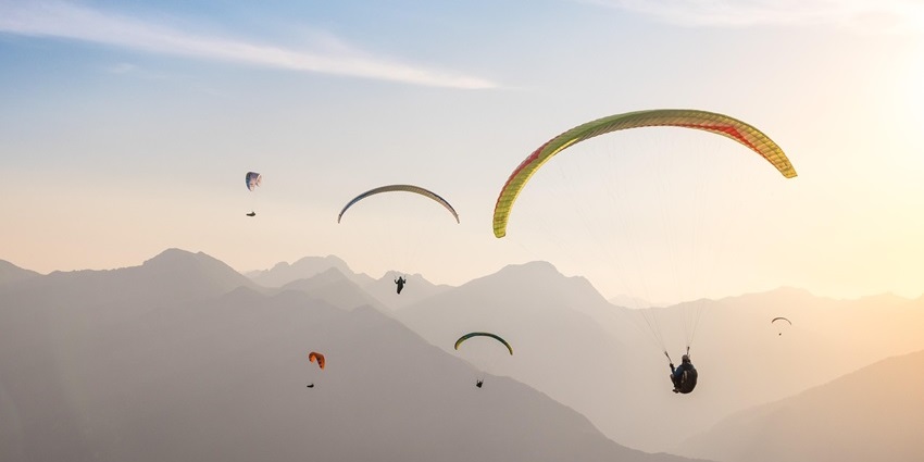 Paragliding in Andaman at sunset over Long Island with golden skies and scenic coastline.