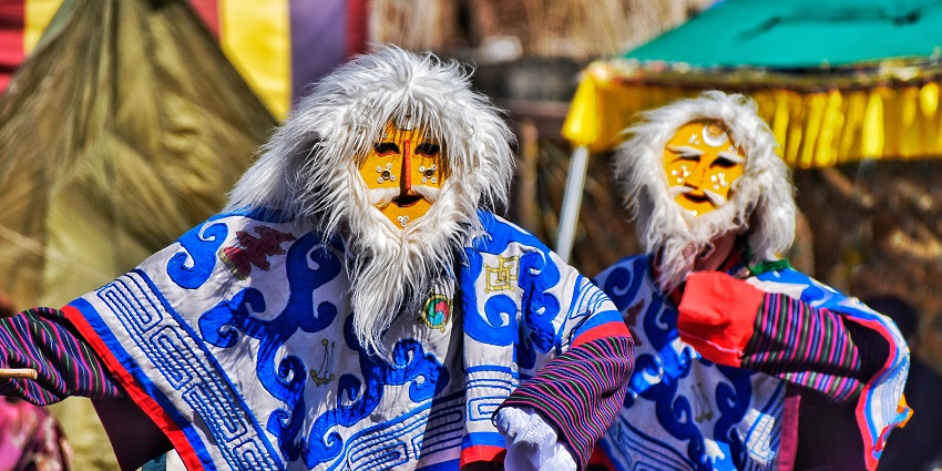 Performers in traditional attire showcasing the Tashi Shoelpa Dance during Losar Festival.
