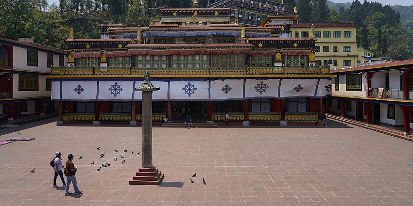 Visitors walking through the courtyard of the historic Rumtek Monastery in East Sikkim.

