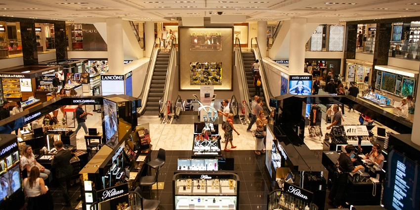 Interior of Lulu Mall with visitors walking and shopping in a lively, well-lit environment.
