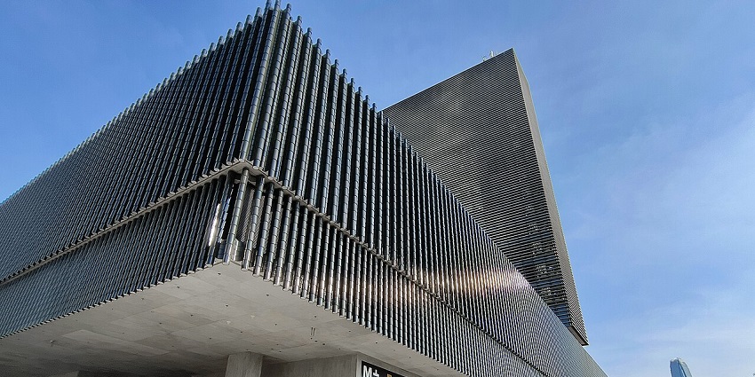 Exterior of M+ Museum in West Kowloon, Hong Kong, with a tall modern facade, one of the museums in Hong Kong.