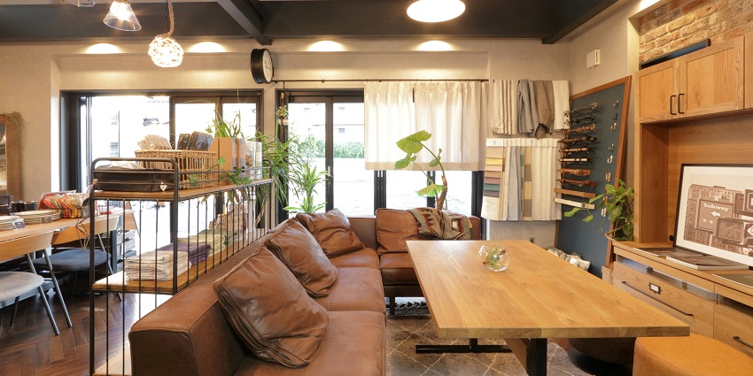 Brown wooden table near a brown couch at MAVI Rooftop Lounge with cosy rooftop ambiance.