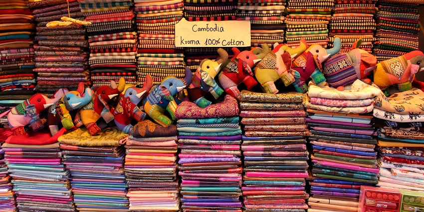 Colorful scarves and handmade toy elephants displayed at Made In Cambodia Market.
