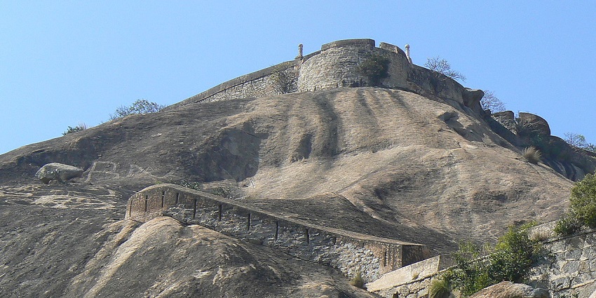 Hilltop structure of Madhugiri Fort built on a massive rocky outcrop with scenic views.