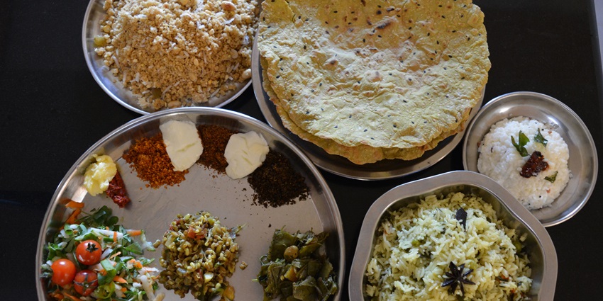 A Karantaka-style food, including rice and papad, is served during Makar Sankranti.