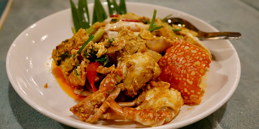 A white plate topped with meat and vegetables is served at Marini’s On 57.