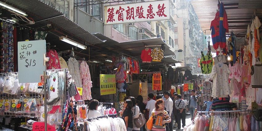 Stalls and crowds at Mong Kok Ladies’ Market, a popular shopping spot in Hong Kong.