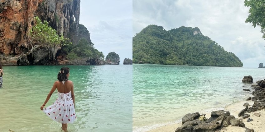 An image of a traveller wearing a white dress with a water body in the background.