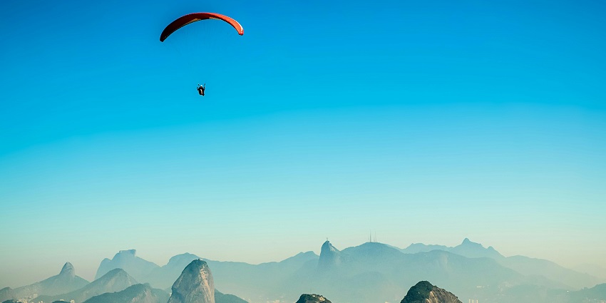 Paragliding at Murudeshwar with clear blue skies and stunning views of the waters.