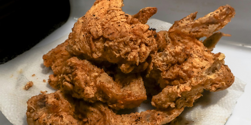 Golden crispy fried chicken served on a plate, ready to eat.