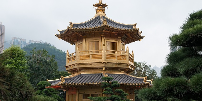 Golden Pavilion surrounded by trees and landscaped greenery inside Nan Lian Garden.
