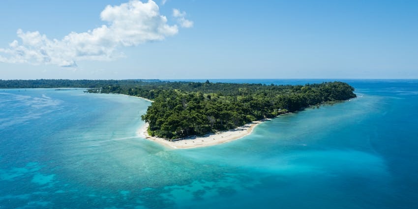 Aerial view of Neil Island showcasing turquoise waters, sandy beaches, and lush greenery.