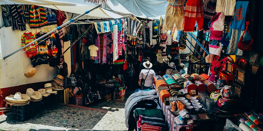 Assorted-color clothes are displayed on the street at New Market for shopping in Sikkim.