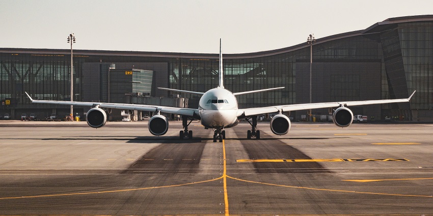White airplane at the terminal building of Ngurah Rai, one of the airports in Bali.
