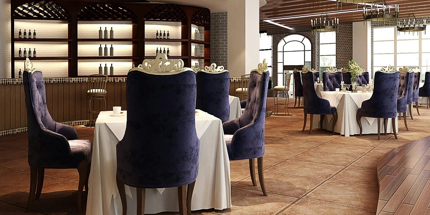 Interior of Nimtho restaurant with a white tablecloth-covered table and purple chairs.
