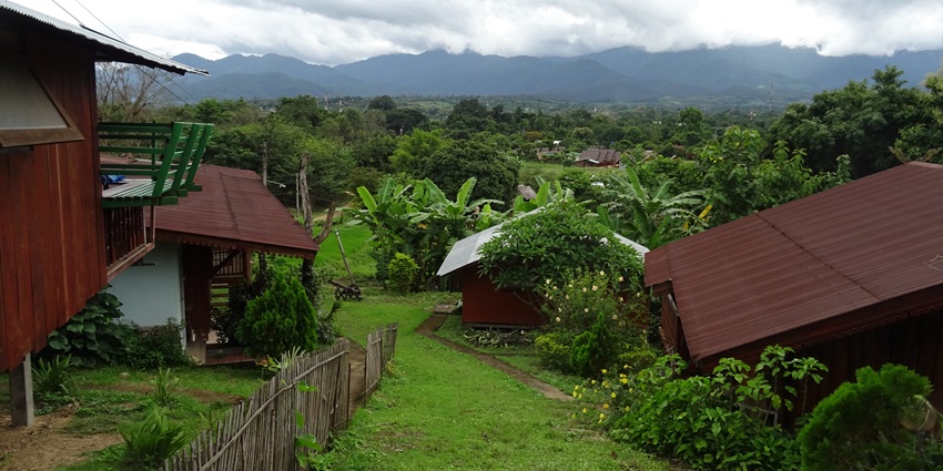 A view of lush hills covered by clouds on top from the countryside in Eastern Pai, Thailand.
