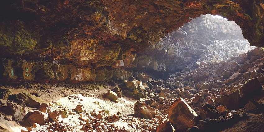 Rocky entrance and natural formations at Pandav Caves, ancient site in Uttarakhand.
