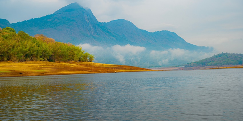 Beautiful landscape view of Parambikulam Dam at Parambikulam Tiger Reserve, ideal for camping in Kerala.