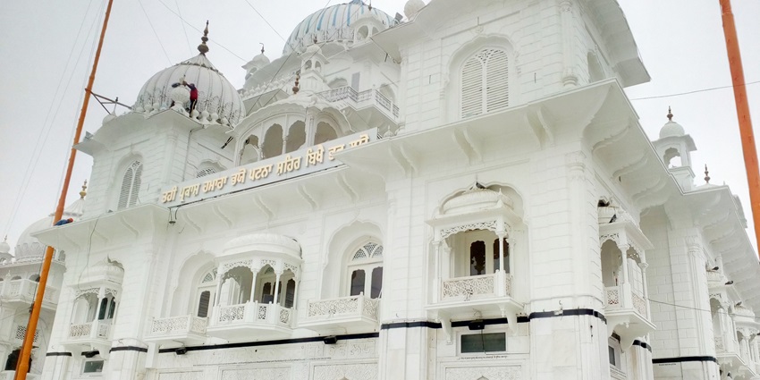 Patna Sahib Gurudwara displays stunning white marble architecture with domes and ornate balconies.