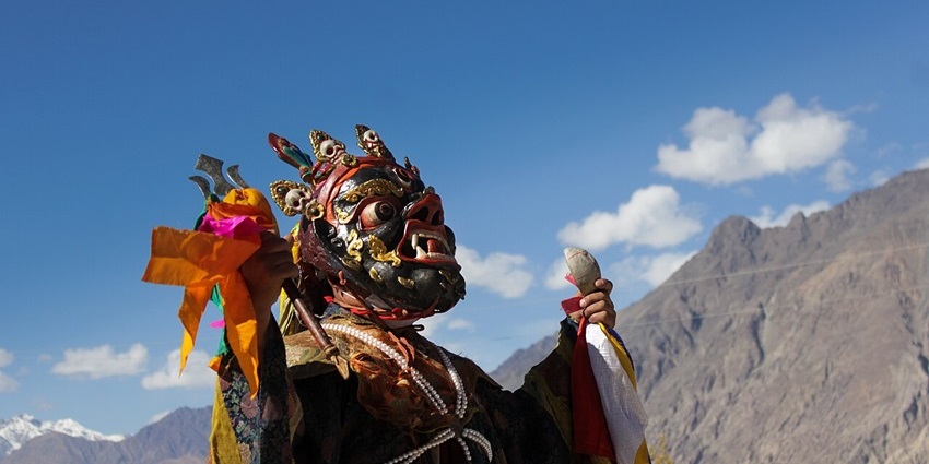A monk wearing a mask performs Cham Dance at a monastery in Ladakh’s Nubra Valley.