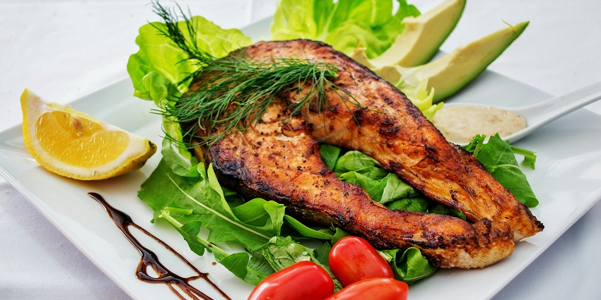 Grilled fish served with a fresh side salad at Premaas Cuisine restaurant.
