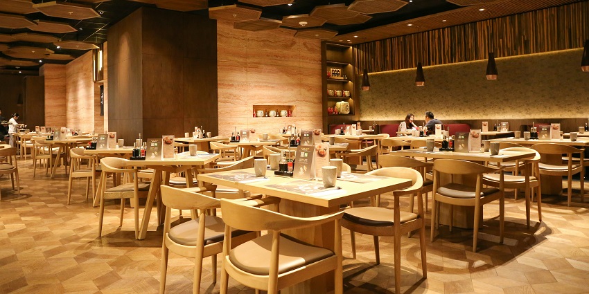 A spacious, elegant, and modern restaurant with many tables and chairs, one of the indian restaurants in Clarke Quay Singapore.
