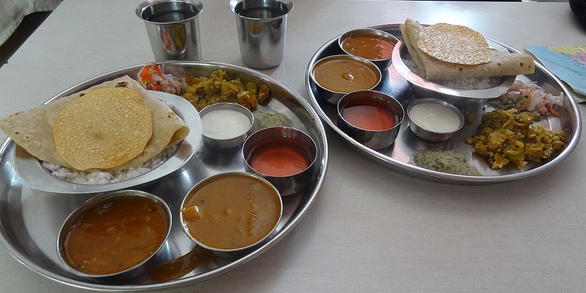 North Indian veg thalis, including chapatis, dal, and sabzis, are served at one of the pure veg restaurants in Neil Island.
