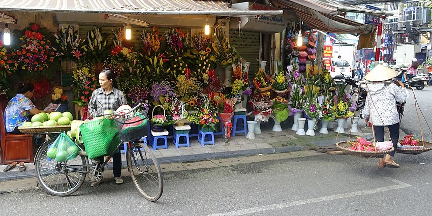 A view of a shop selling a variety of flowers inside a flower market in Hanoi, Vietnam.
