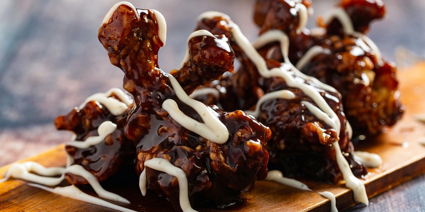 Fried chicken legs in sweet glaze served at Queen's Kitchen, Indian restaurants in Cappadocia Turkey.
