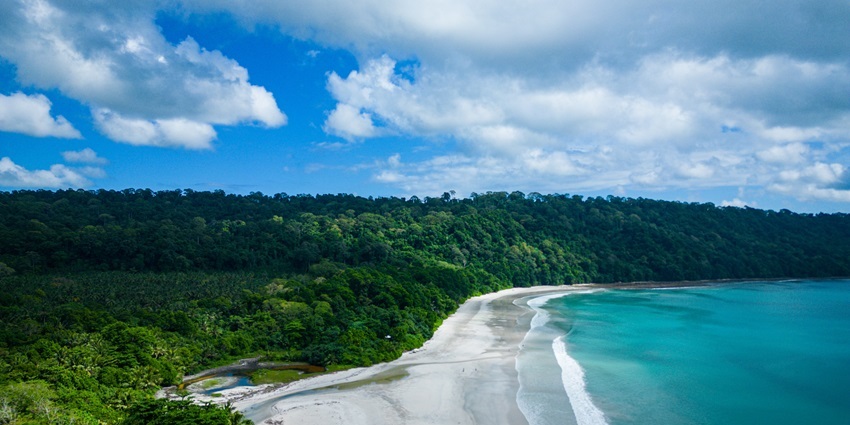 Aerial view of Radhanagar Beach with turquoise waters and sandy shoreline.