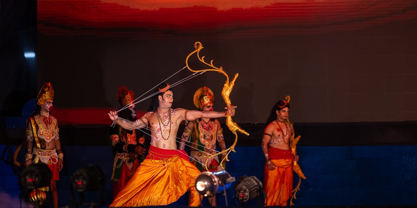 Actors dressed as royalty and sages enact a dramatic scene during a Ram Leela performance.