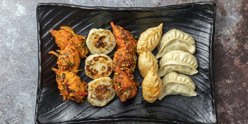 Steamed and fried momos platter served with dips at Red Hot Chilli Pepper.