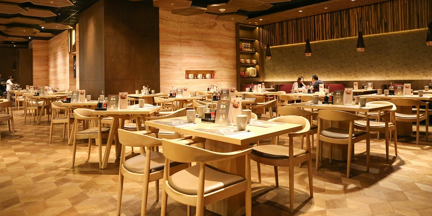 Interior of Revolver Restaurant with a large room featuring tables and chairs.
