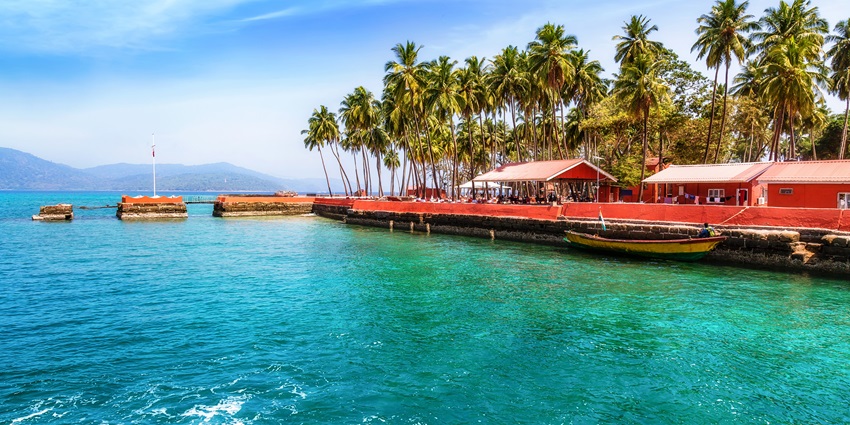 View of beautiful Ross Island with palm trees and blue water, one of the most stunning islands in the Andaman.