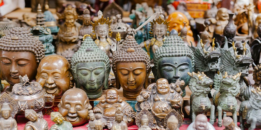 Buddha busts and figurines on display at Russian Market for shopping in Cambodia.
