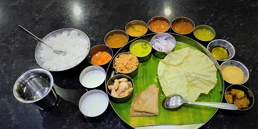 South Indian vegetarian thali with rice, curries, and sides at Saravanaa Bhavan in Kuala Lumpur.