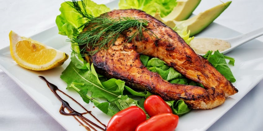 Grilled fish served at Schilleci’s New Orleans Kitchen in a cosy restaurant setting.