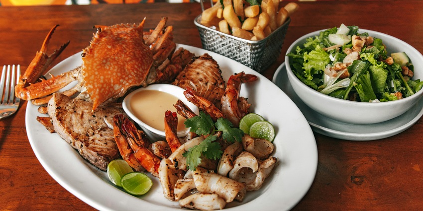 Close-up photo of seafood served on a ceramic plate at Sea Dragon Restaurant.