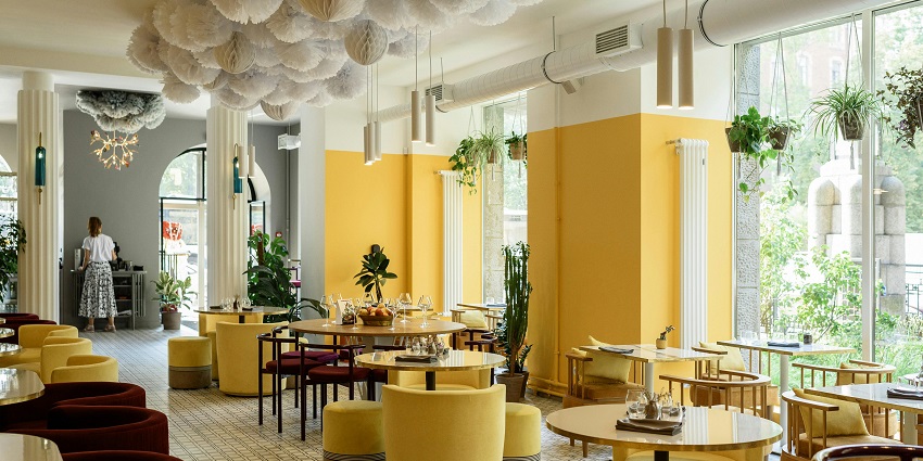 Stylish dining room with yellow walls, eclectic furniture, and unique decor, Indian restaurants in Clarke Quay, Singapore.
