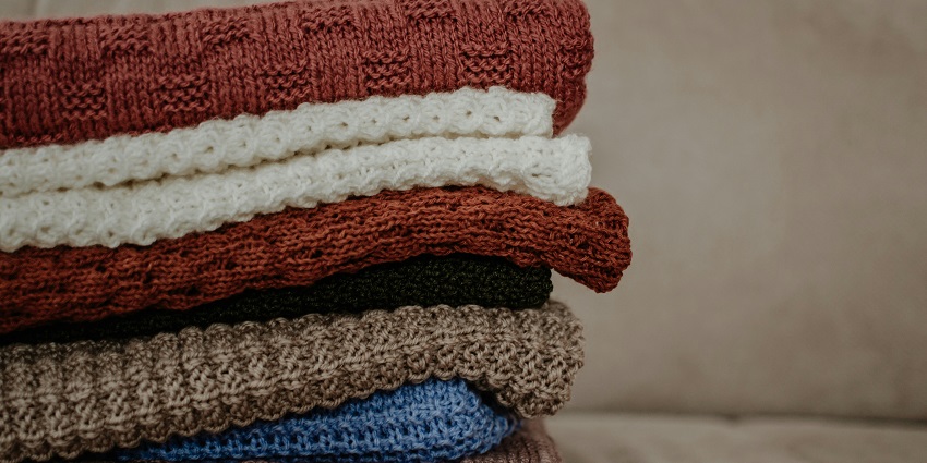 Stack of warm woolen sweaters at Shar Market, perfect for shopping in Ladakh.
